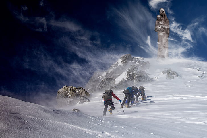 group of people hiking on snow mountain