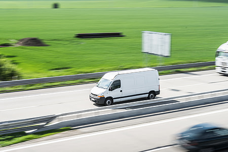 White Delivery Van in Motion Driving on Highway