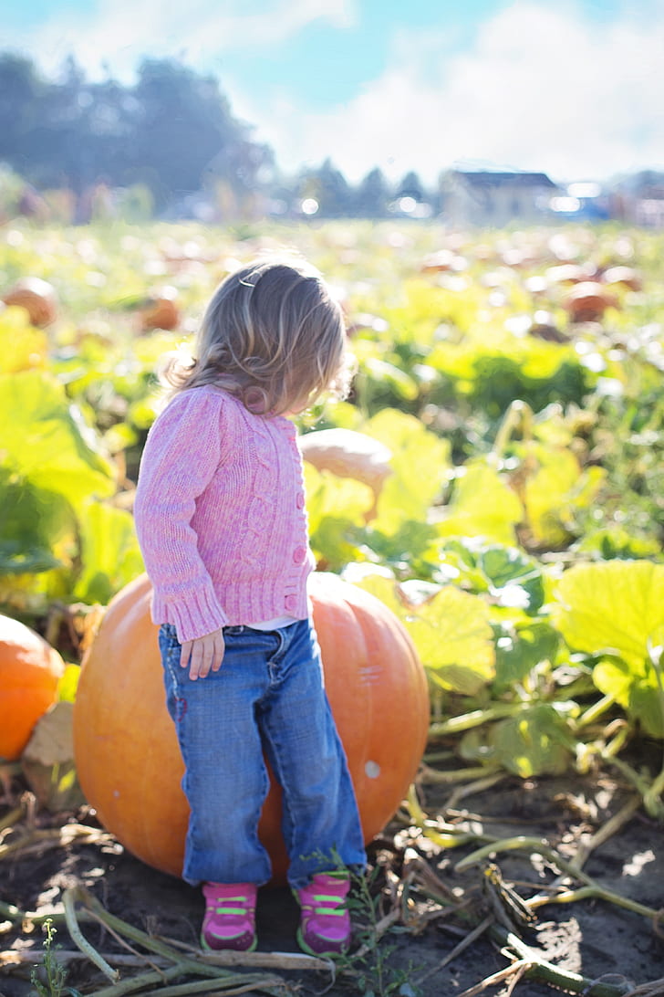 girl sitting on pumpkin