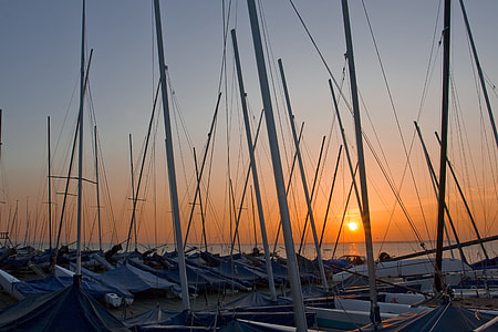 Wide-angle shot of boat masts at sunset on the coast of Whitstable in Kent, England