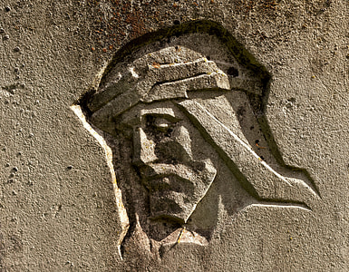 Jesus face carved on brown concrete wall