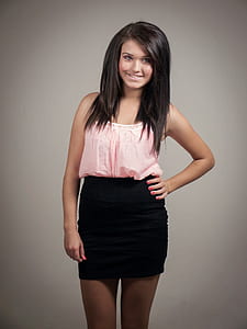 woman wearing pink spaghetti-strap top and black skirt