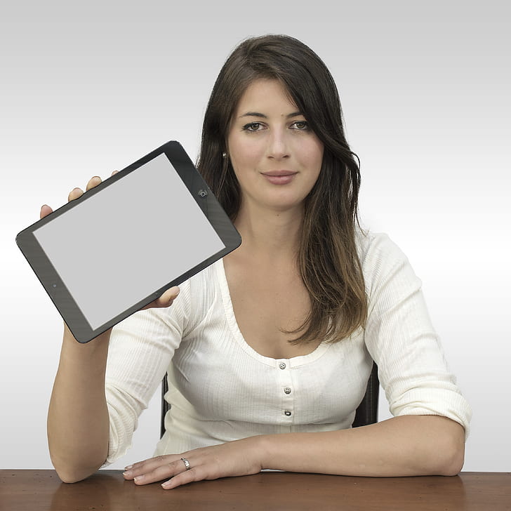 photo of woman holding black tablet computer