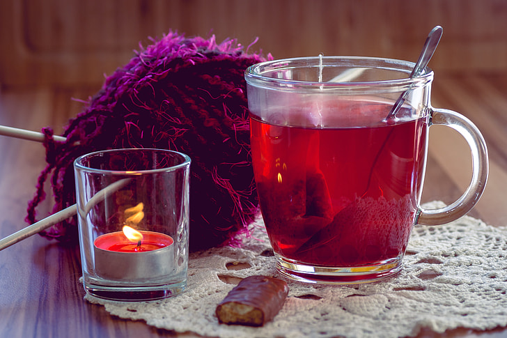 turkish mug beside tealight candle holder and purple yarn