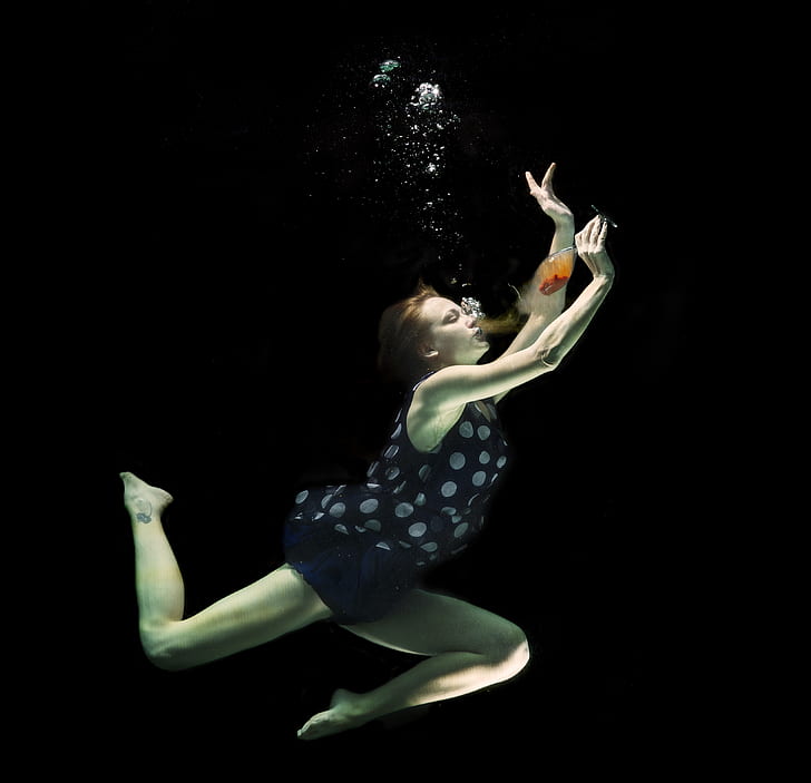 woman drinking wine under water
