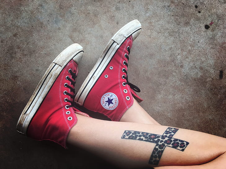 photo of person wearing red Converse Chuck Taylor high-rise