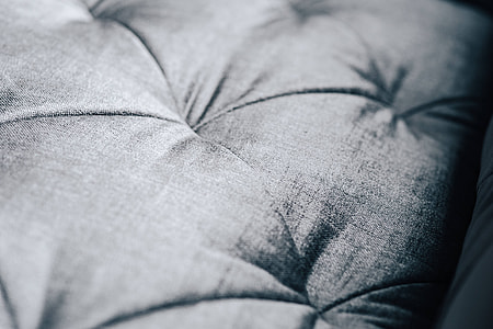 Close-ups of pillows and a grey sofa