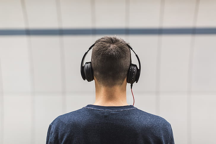 selective focus photo of man wearing black headphones