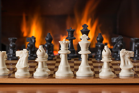 white, black, and brown Chess pieces on chess board