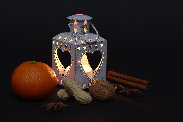 photo of lantern beside orange and peanuts
