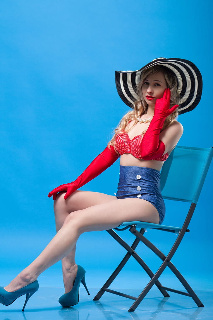 woman wearing red bikini top and blue bottoms