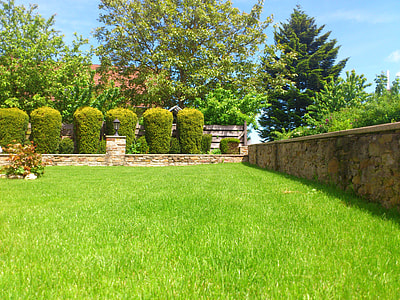 brown brick wall on green field