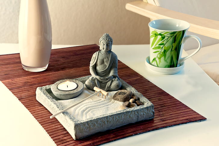 Buddha ceramic figurine on tray