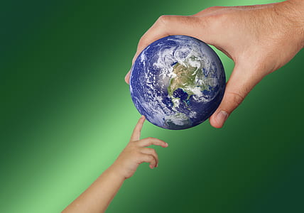 man and toddler holding earth