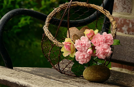 brown wicker basket with pink roses accent