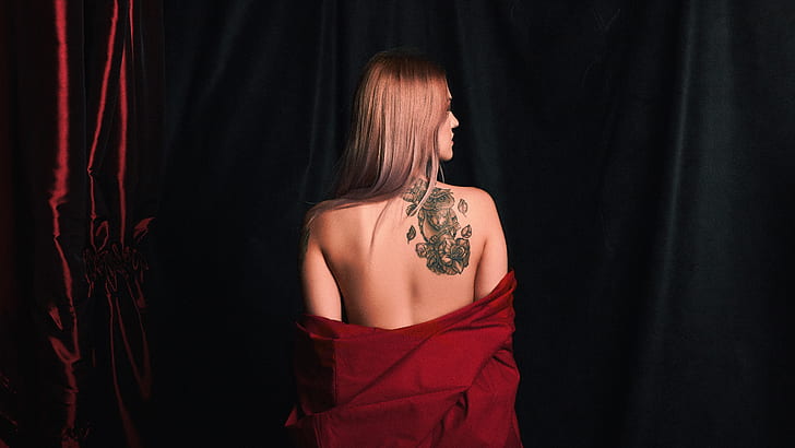 women's red top with tattoo on her back