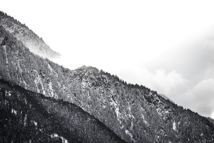 gray scale mountain range photo shot during daytime