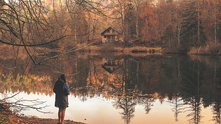 woman standing near pond