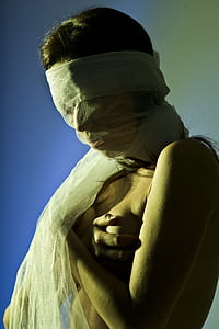 woman naked with white textile on her face