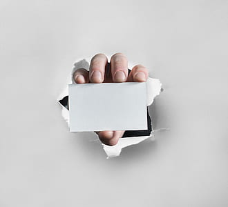 person holding white blank card