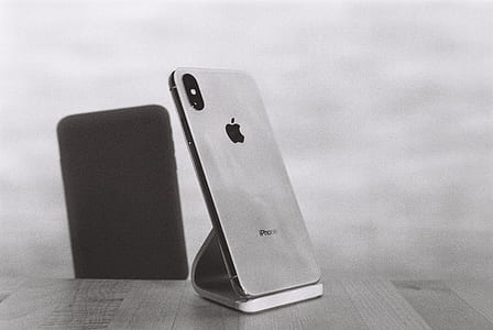 silver iPhone X on table