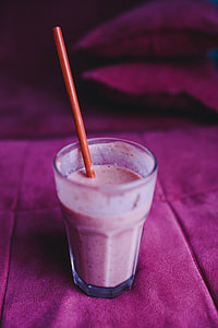Fresh and healthy fruit milkshake with a straw
