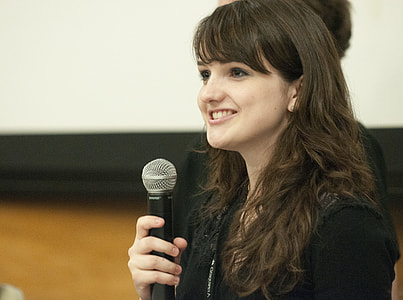 woman holding black microphone