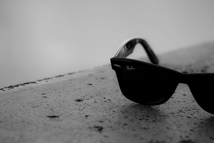 greyscale photo of black Ray-Ban Wayfarer sunglasses