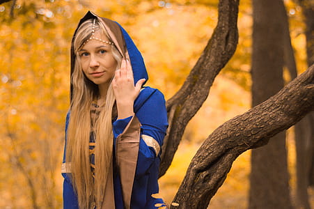 shallow focus photography of woman wearing blue robe