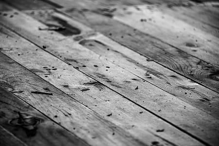 wood planks in greyscale photography
