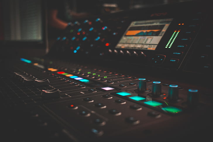photo of black and green lighted mixing console