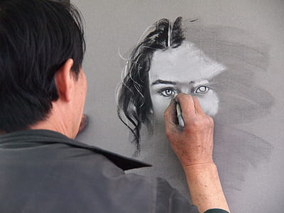 person drawing female on gray surface