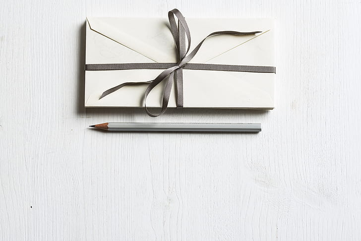 envelope card beside gray pencil