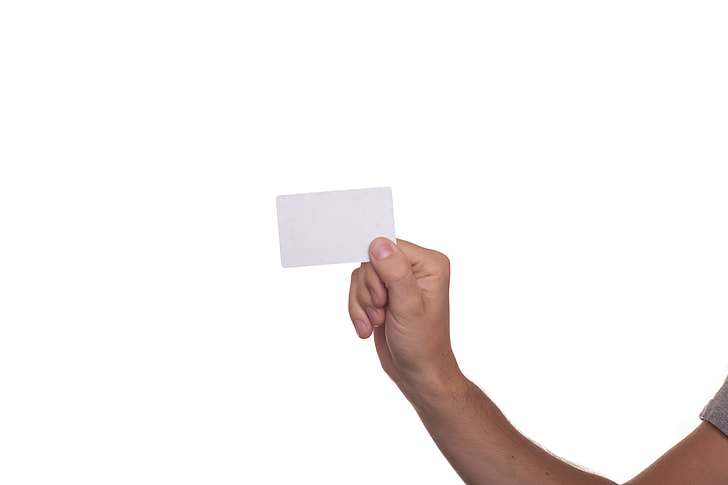 person's right hand holding white card