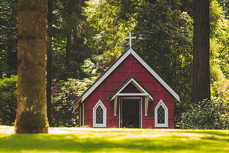 Red Chapel on Grassy Field With Trees