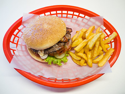 burger and fries on red plastic basket
