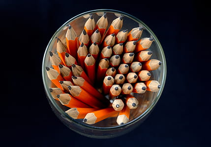 photo of brown pencils in clear container