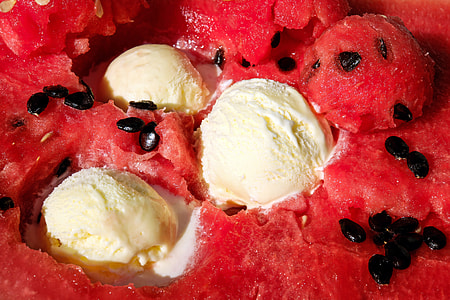 close-up photo of watermelon flavored ice cream with three scoops of vanilla ice cream