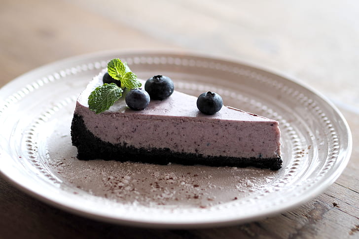 cake slice topped with blueberries