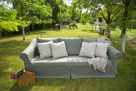 gray fabric sofa and four white throw pillows