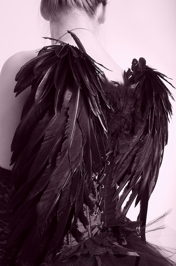woman wearing black dress with wings