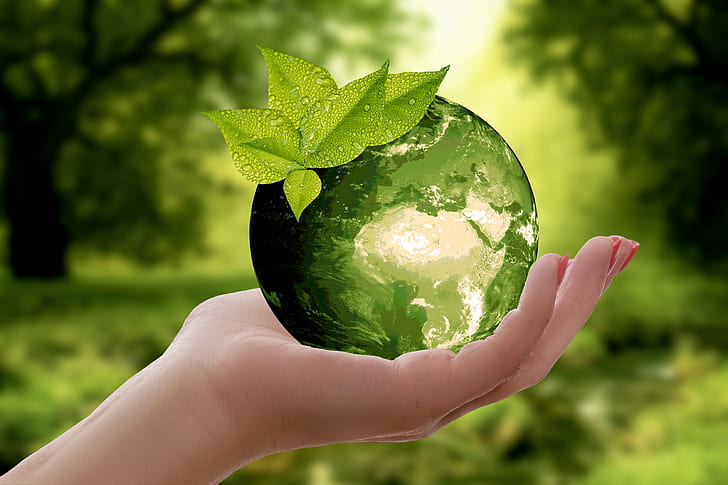 person holding green crystal ball
