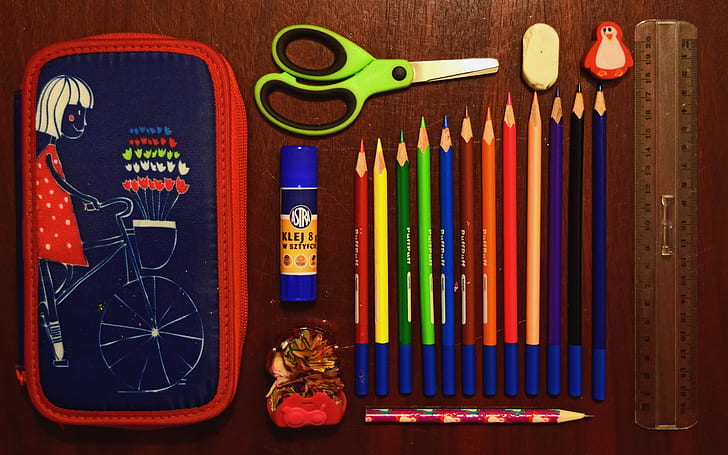 coloring pencils near on scissor and eraser