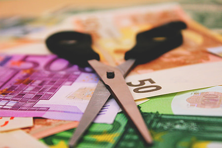 Cash bank notes and scissors