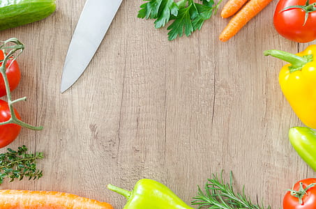 silver kitchen knife and assorted vegetables