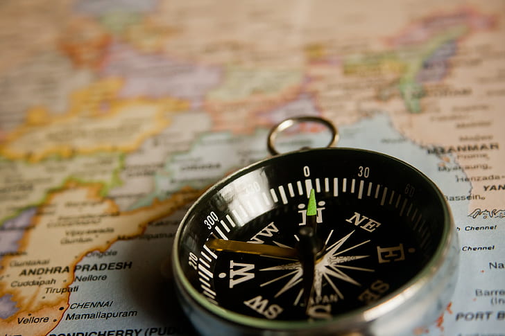 closeup photo of silver-colored compass