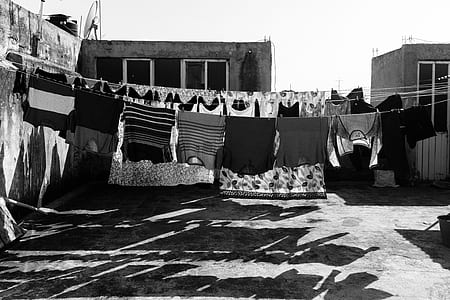hanging clothes grayscale photo