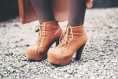 Closeup shot of a woman’s feet and brown boots