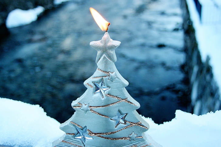 selective-focus photography of lit white Christmas tree candle