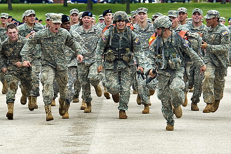 army running on concrete road during daytime